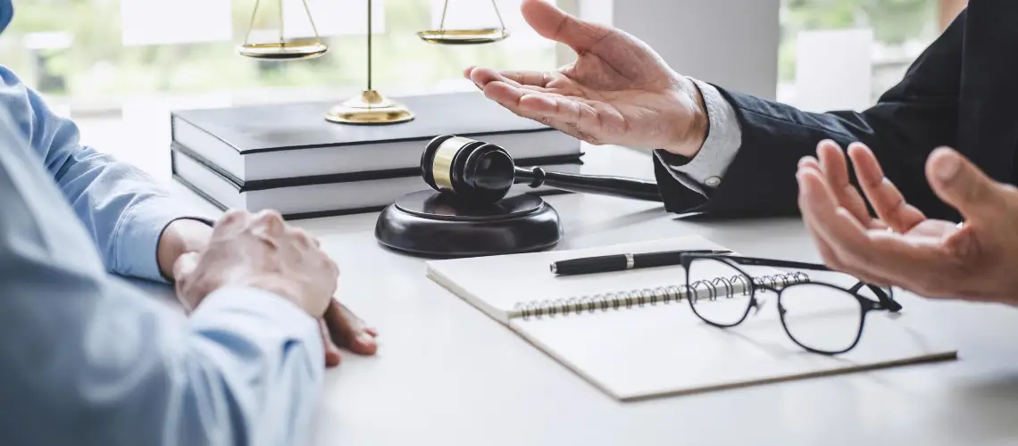 A gavel placed beside a cannabis leaf